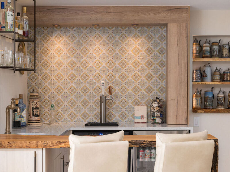 A two barstool size custom bar fits nicely into a basement corner. Remodel and design by SoBo Homes.