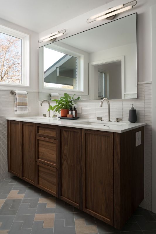 A new window was placed above a vanity, and a boomerang shaped floor tile adds an interesting look in the revamped bathroom.